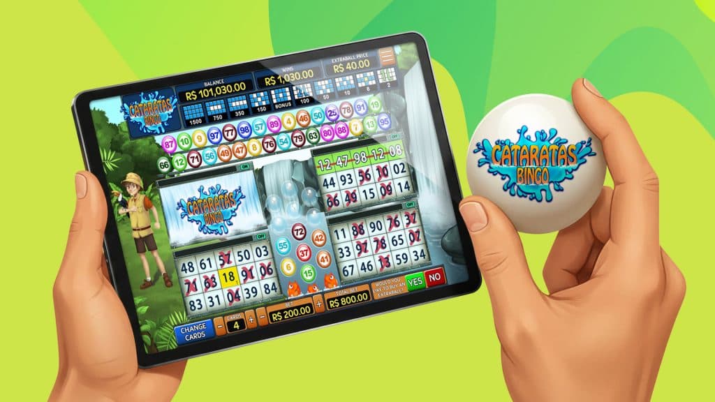 On an iPad, we see the game Bingo Cataratas. A hand holds a white bingo ball to the right of the screen with the game’s name.