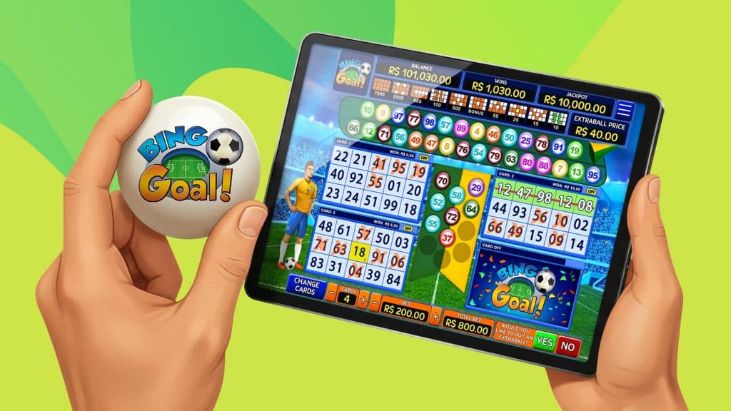 In a lime green image, a hand holds a white bingo ball that has the bingo game “Bingo Goal” displayed on it. The game is in action on a tablet or iPad.