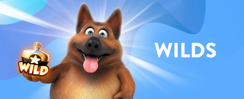 A 3D-animated character of a dog is seen from the waist up, standing up straight with its tongue hanging out, holding up a Wild symbol from a SlotsLV slots game. To the right is the word “Wilds”, in white.