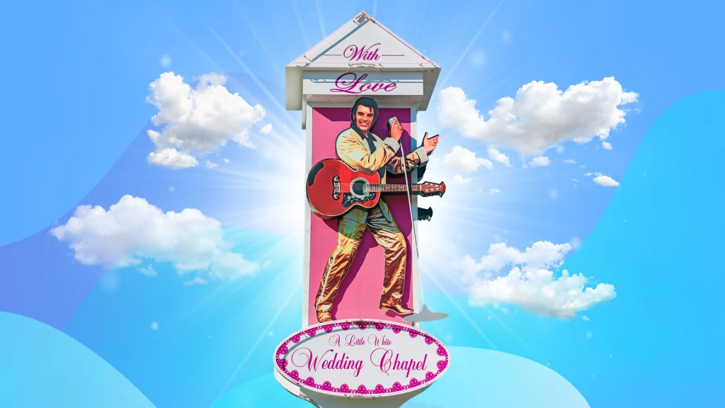 A Vegas wedding chapel sign with an affixed life-size Elvis cutout is set against a blue sky background.
