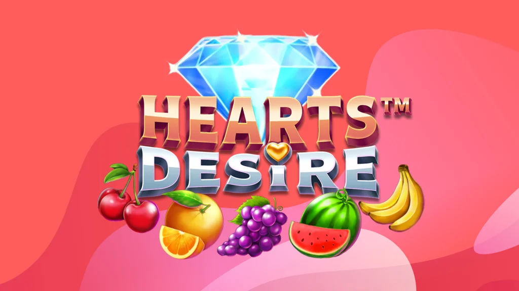 The logo for the SlotsLV casino online slot, Hearts Desire, is centered, adjacent to a diamond and fruit symbols from the slot including a watermelon, cherry and bananas, on a pink background. 
