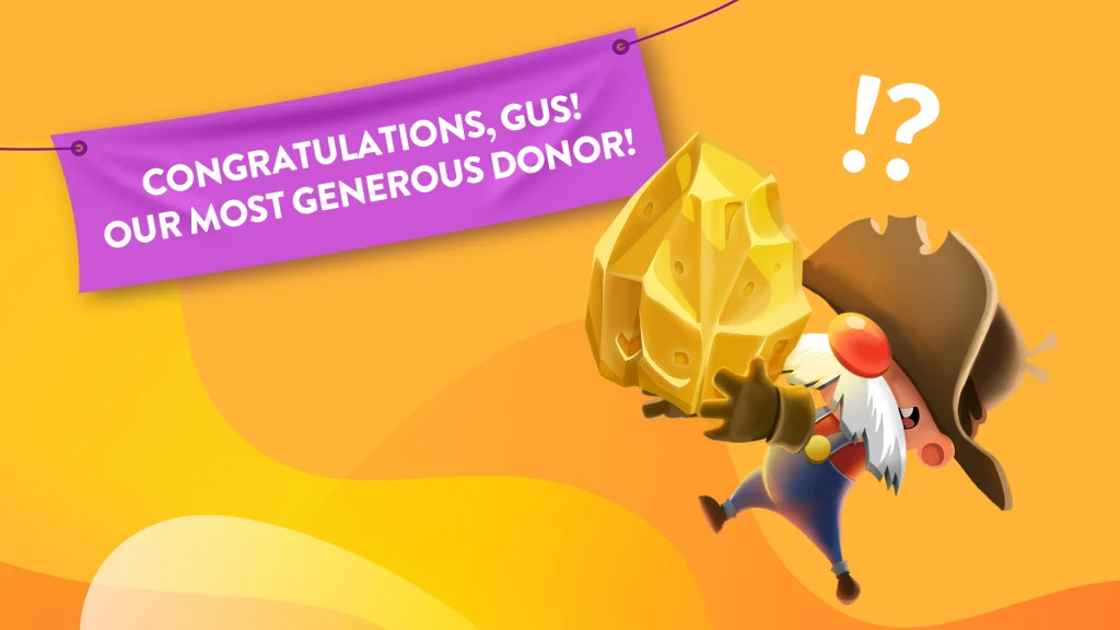 There’s a purple banner on a yellow background that says, “Congratulations, Gus, Our Most Generous Donor!” to the left of a mustached prospector holding a huge golden nugget.